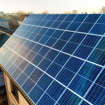 aerial-view-new-modern-two-story-house-cottage-with-blue-shiny-solar-photo-voltaic-panels-system-roof-renewable-ecological-green-energy-production-concept